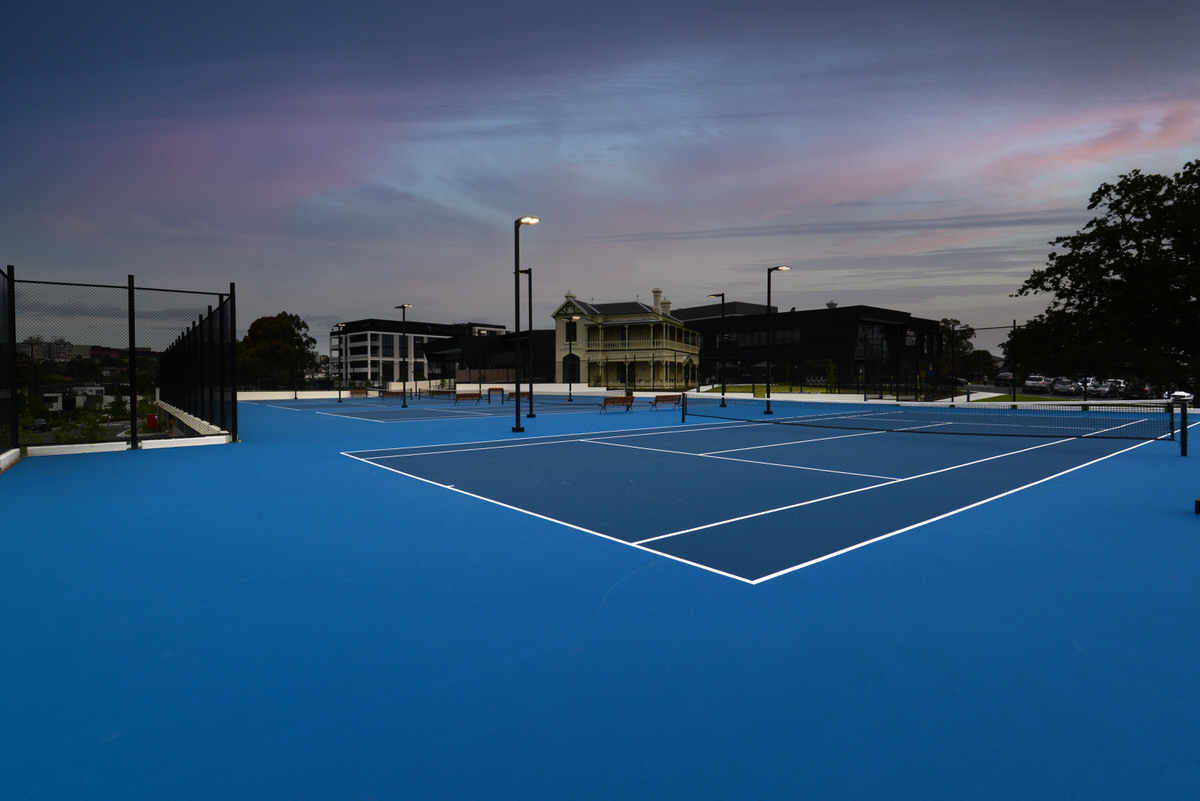 4 Tennis courts lit at dusk