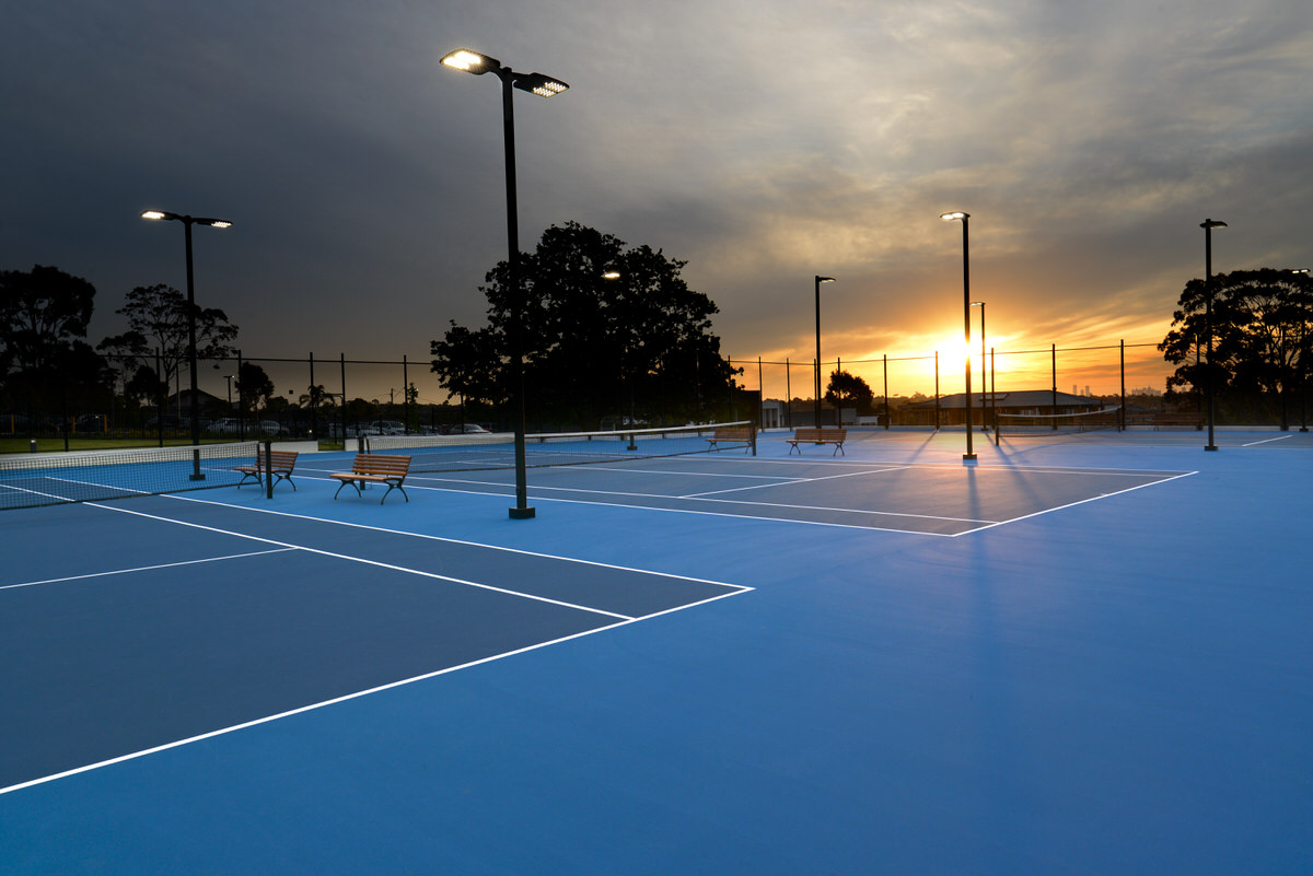 Wide angle shot of tennis court under lights